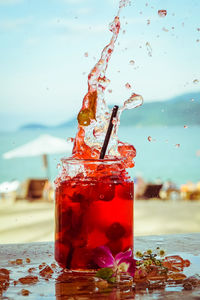 Close-up of water splashing in glass on table