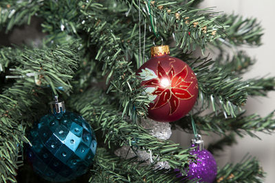 Blue, red, and glittery purple globes near a clear star-shaped decoration