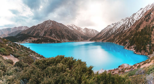 Lake and mountains against sky