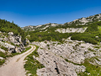 Scenic view of mountains against clear blue sky