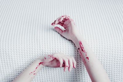 Close-up of woman hand with pink petals