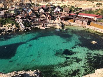 High angle view of buildings by sea