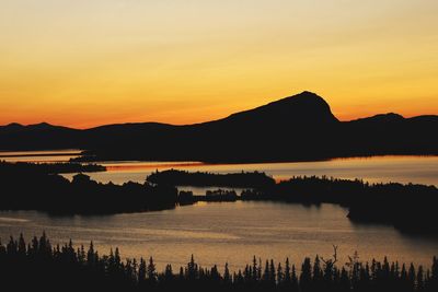 Scenic view of lake against romantic sky at sunset