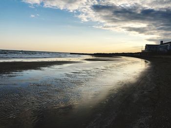 Scenic view of beach against sky during sunset