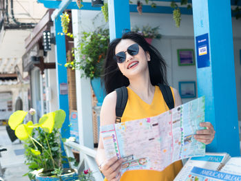 Young woman wearing sunglasses standing outdoors