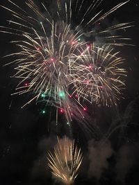 Low angle view of firework display at night