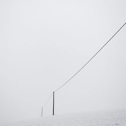 Scenic view of snowy field against clear sky
