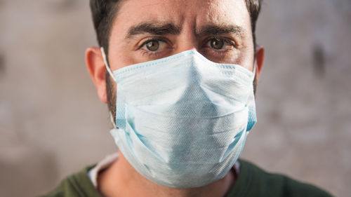 Close up portrait of man wearing medical face mask