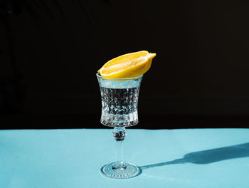 Close-up of drink on table against black background