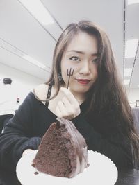 Portrait of young woman with ice cream