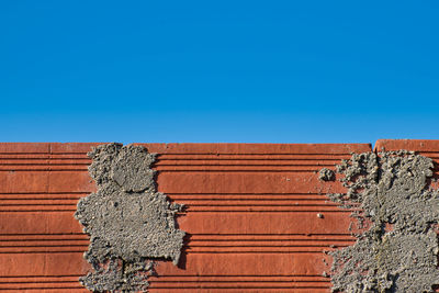 Low angle view of old building against blue sky