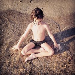 High angle view of woman sitting on beach