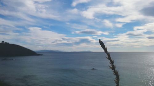 Scenic view of sea against cloudy sky