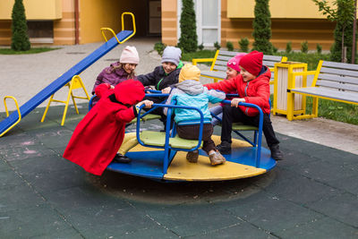 Kids on carousal in playground