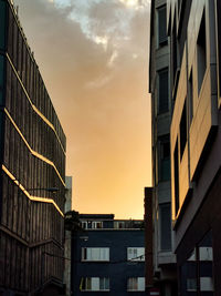 Low angle view of buildings against sky during sunset