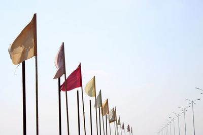 Low angle view of flags against clear sky