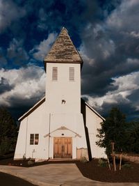 Low angle view of building against cloudy sky