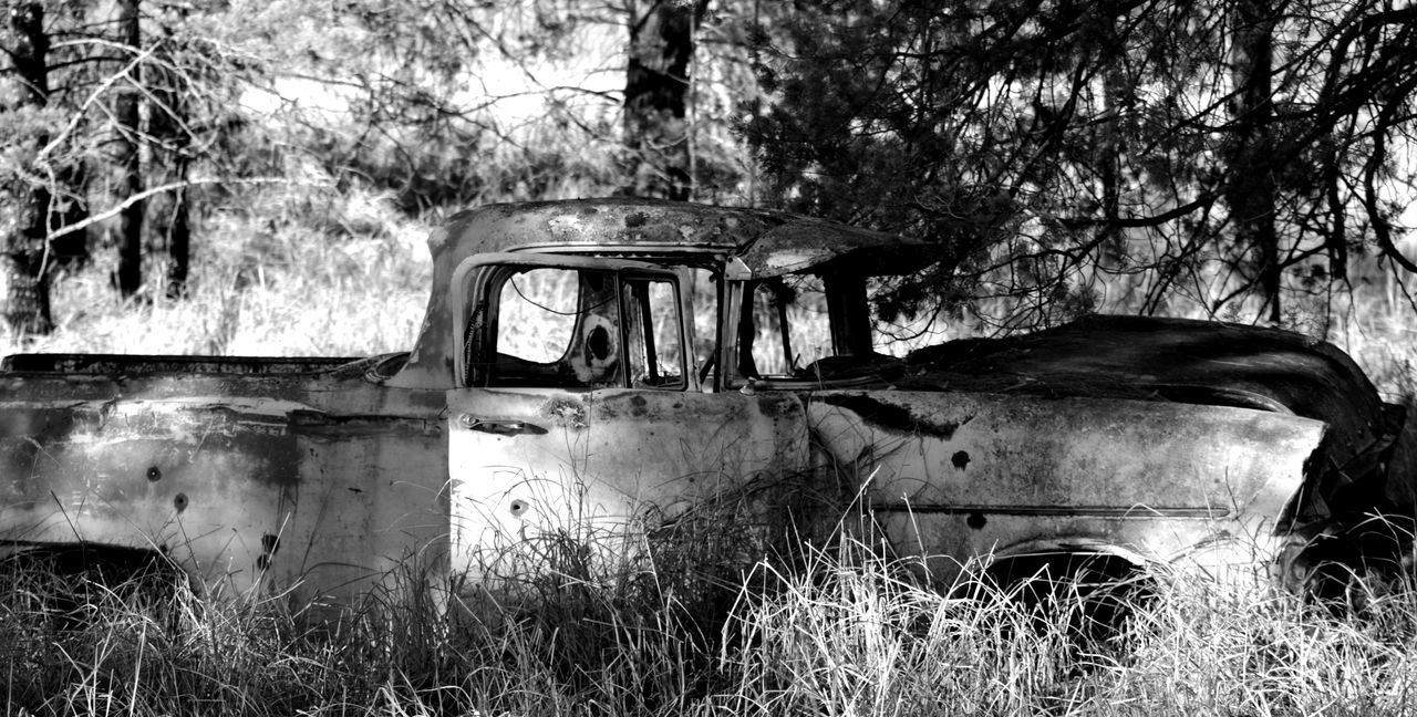 ABANDONED VEHICLE ON FIELD