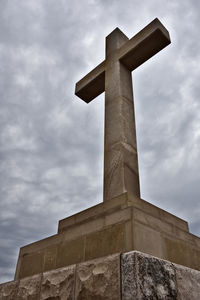 Low angle view of cross against sky