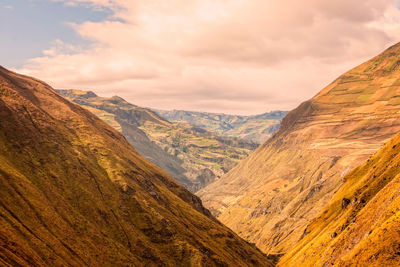 Scenic view of mountains against cloudy sky