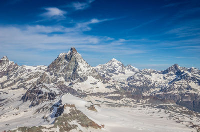 Scenic view of snowcapped mountains against sky