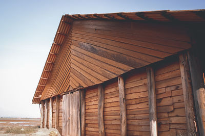 Low angle view of wooden salt storage house against sky