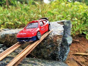 Red toy car on rock