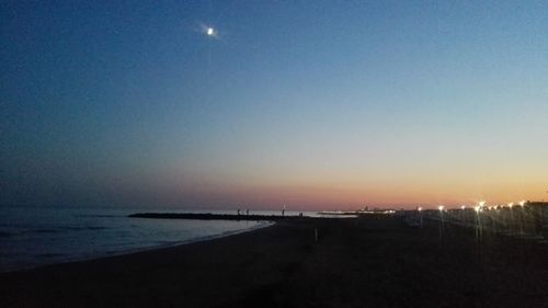 Scenic view of sea against clear sky at sunset