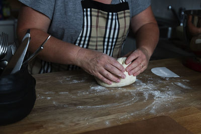 Midsection of man preparing food at home