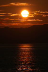 Scenic view of sea against romantic sky at sunset