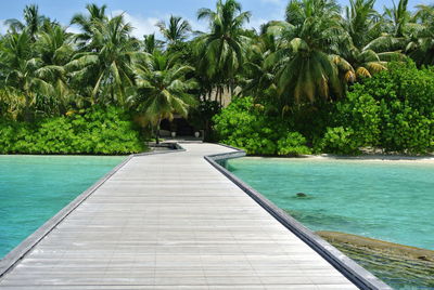 Scenic view of swimming pool by sea against sky