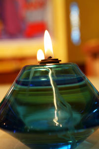 Close-up of illuminated lamp on table