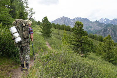 Rear view of man hiking on mountain