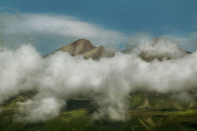 Smoke emitting from volcanic mountain against sky