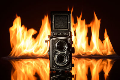 Close-up of fire burning against black background