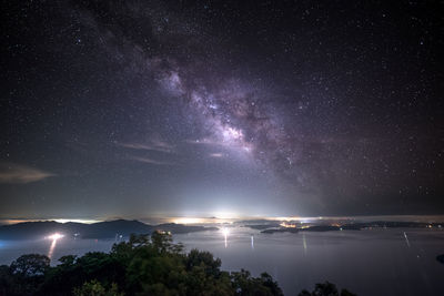 Scenic view of sea against star field