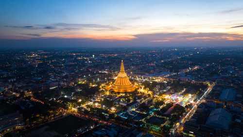 High angle view of illuminated cityscape against sky during sunset