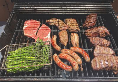 High angle view of meat on barbecue grill