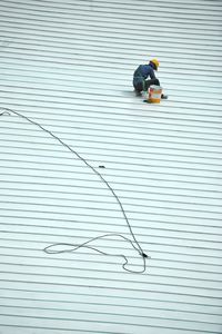 High angle view of man working on metal