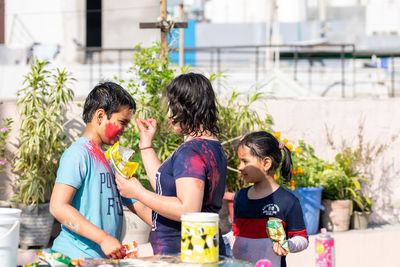 Kids applying color on each other