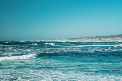 Scenic view of sea against clear blue sky