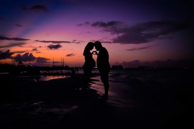 Silhouette woman standing against sky during sunset