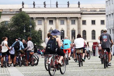 People riding bicycles on street in city