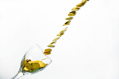 Close-up of yellow decorations over white background