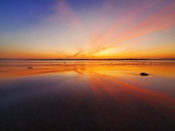 Scenic view of sea against romantic sky at sunset