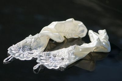 High angle view of white crumpled gloves on glass