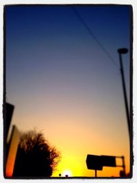 Low angle view of silhouette trees against sky at sunset