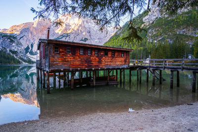 Built structure by lake against trees