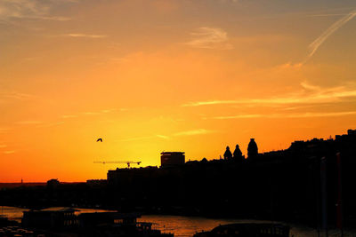 Silhouette buildings against sky during sunset