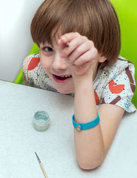 Portrait of cute boy sitting at table